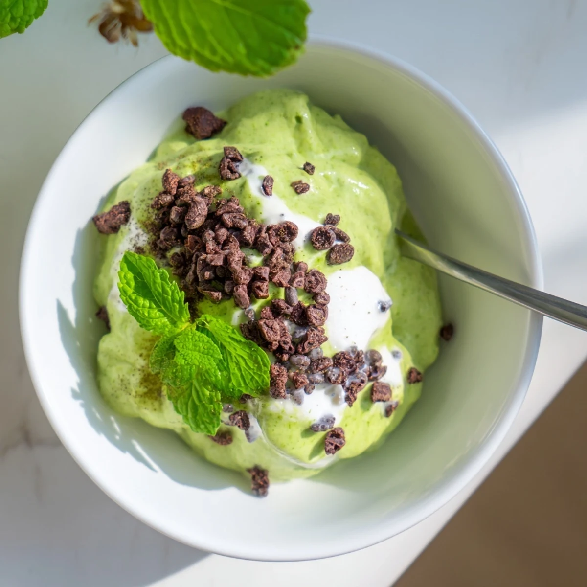 Smooth, vibrant Grinch Green Mint Matcha Breakfast Chia Pudding topped with crunchy cacao nibs makes a delicious breakfast.