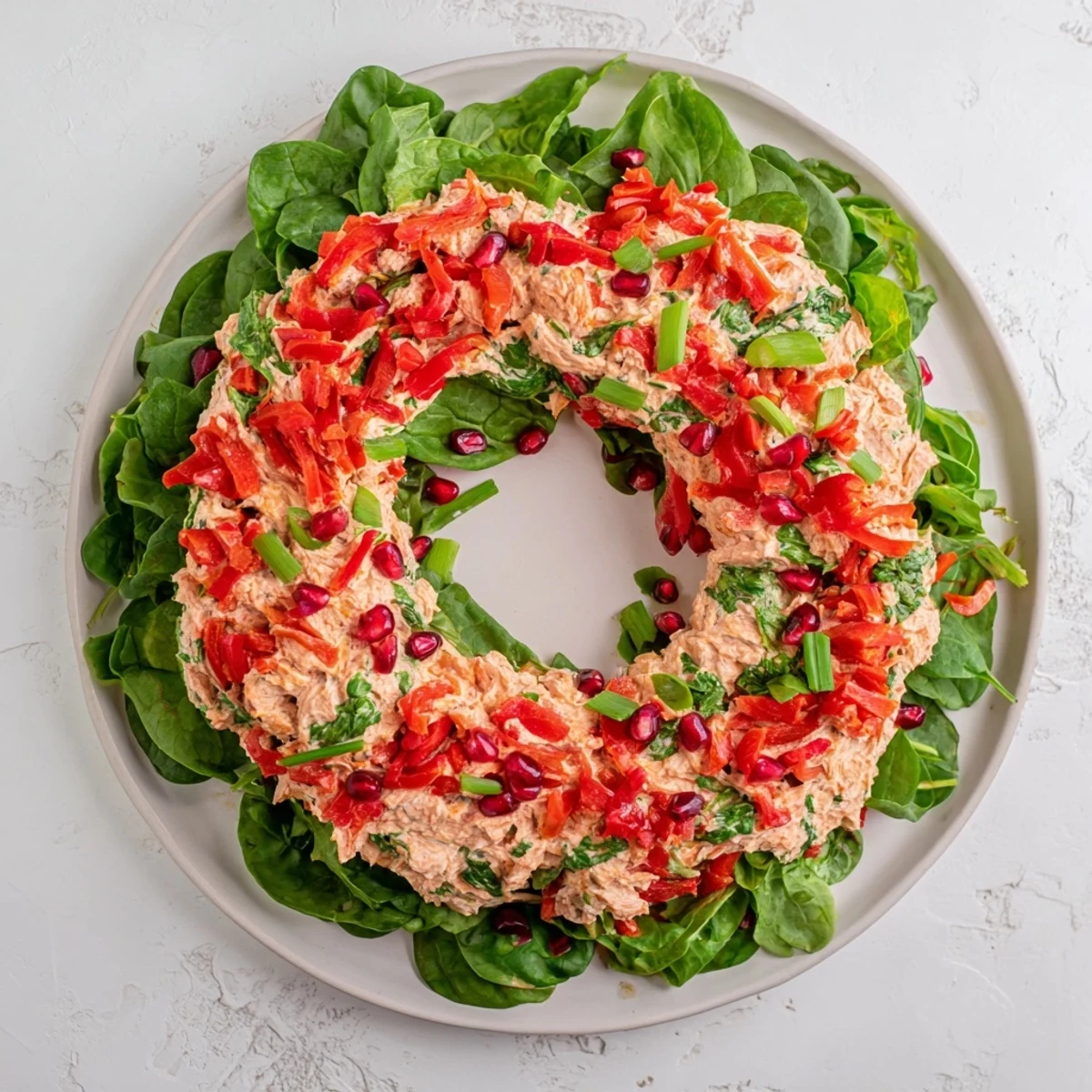 Vibrant Red Pepper and Spinach Dip Wreath: Imagine a beautiful holiday wreath of creamy dip topped with bright pomegranate seeds.