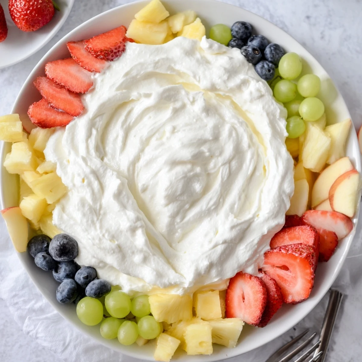 This decadent cream cheese fruit dip, smooth and fluffy, is perfect for your next party.
