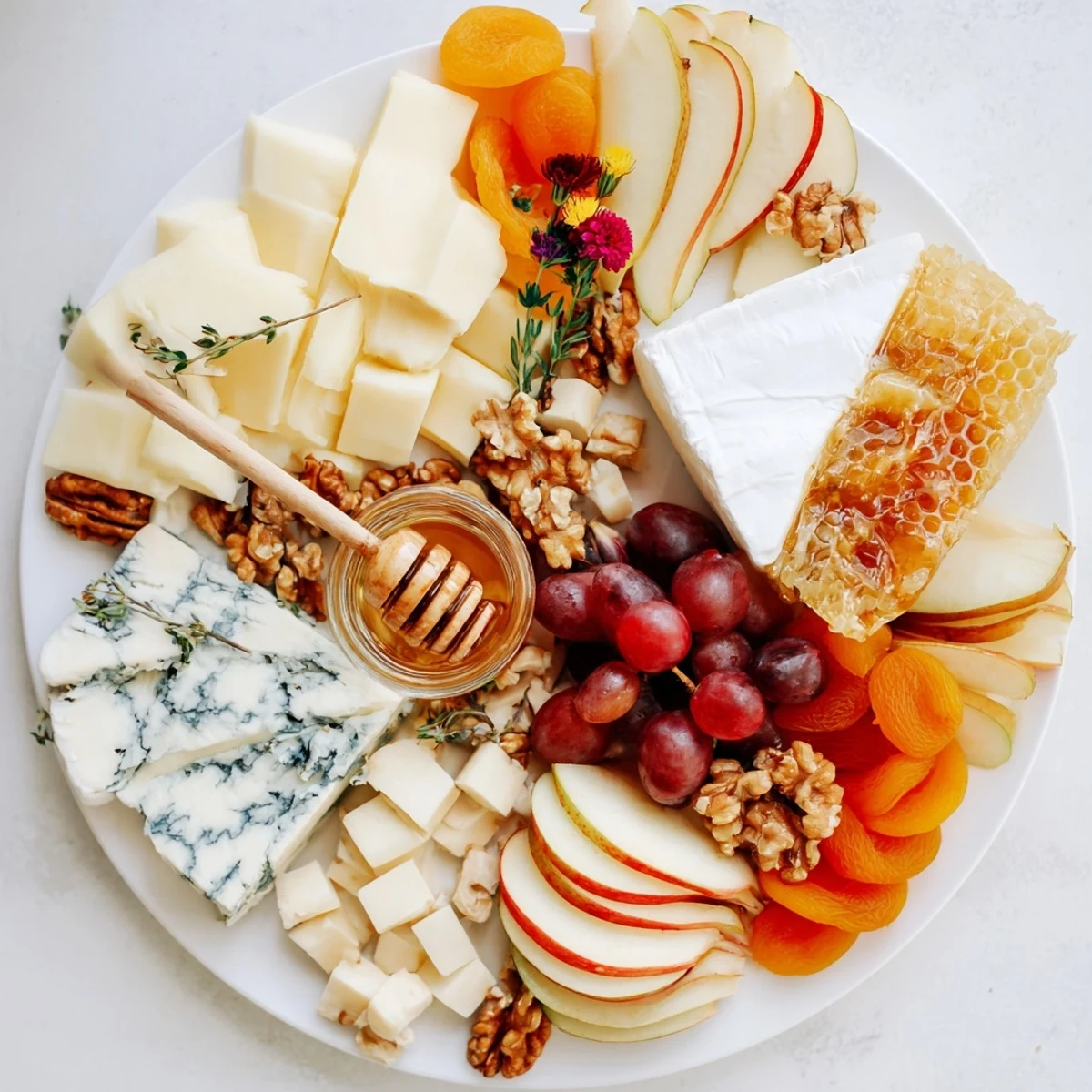A selection of cheeses and sweet honeycomb displayed on the Honey & Cheese Board, perfect for sharing.