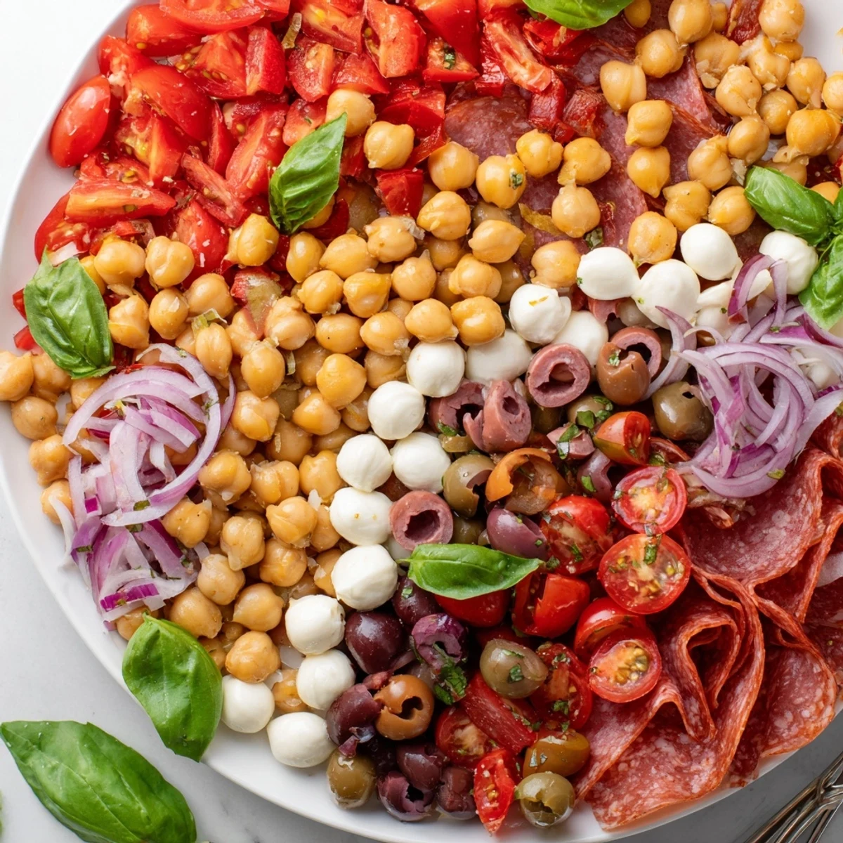 Tangy Italian dressing coats a bright mix of ingredients in this delicious Antipasto Chickpea Salad recipe.
