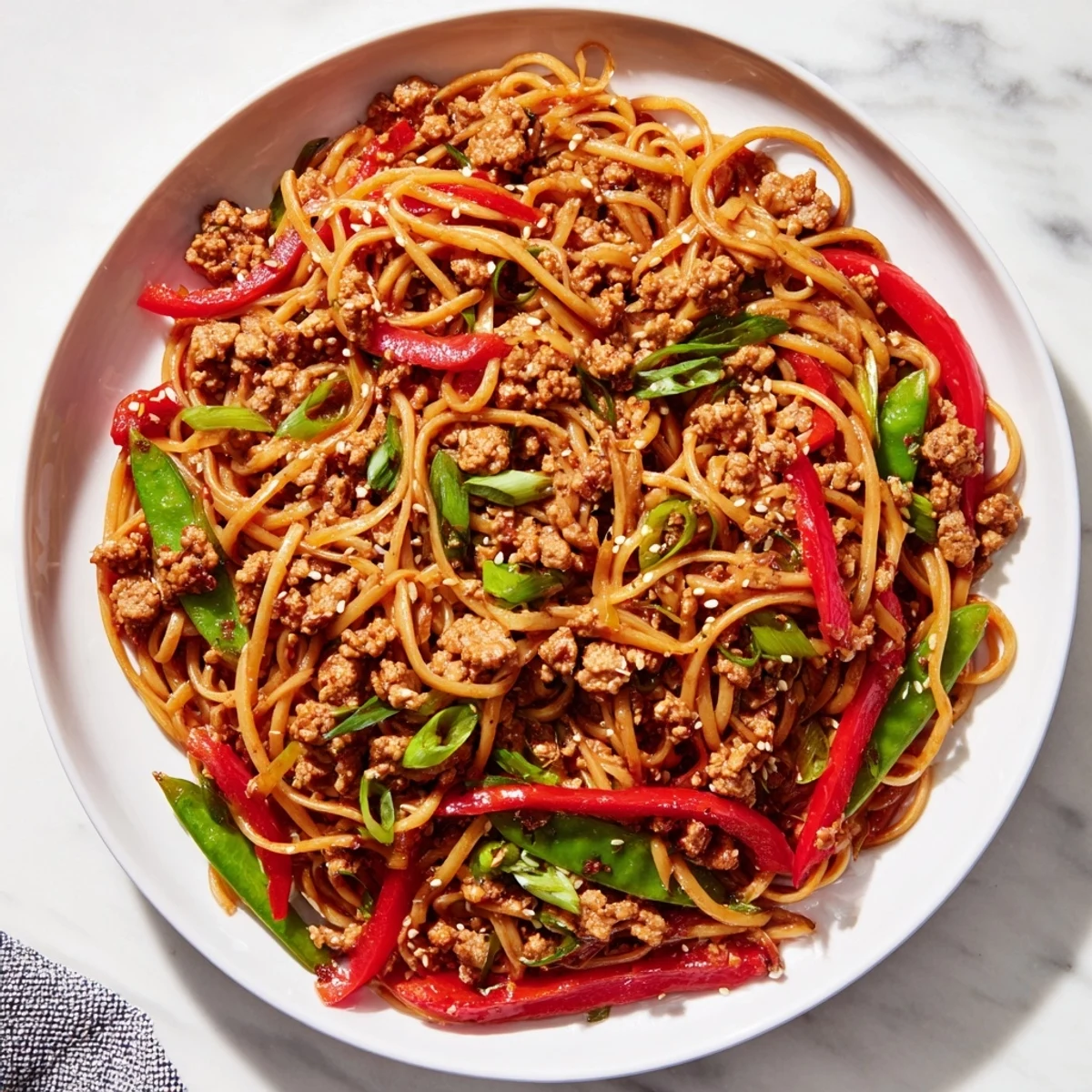 Tender ground chicken and vibrant vegetables shine in this flavorful Sesame Hoisin Pasta dish.