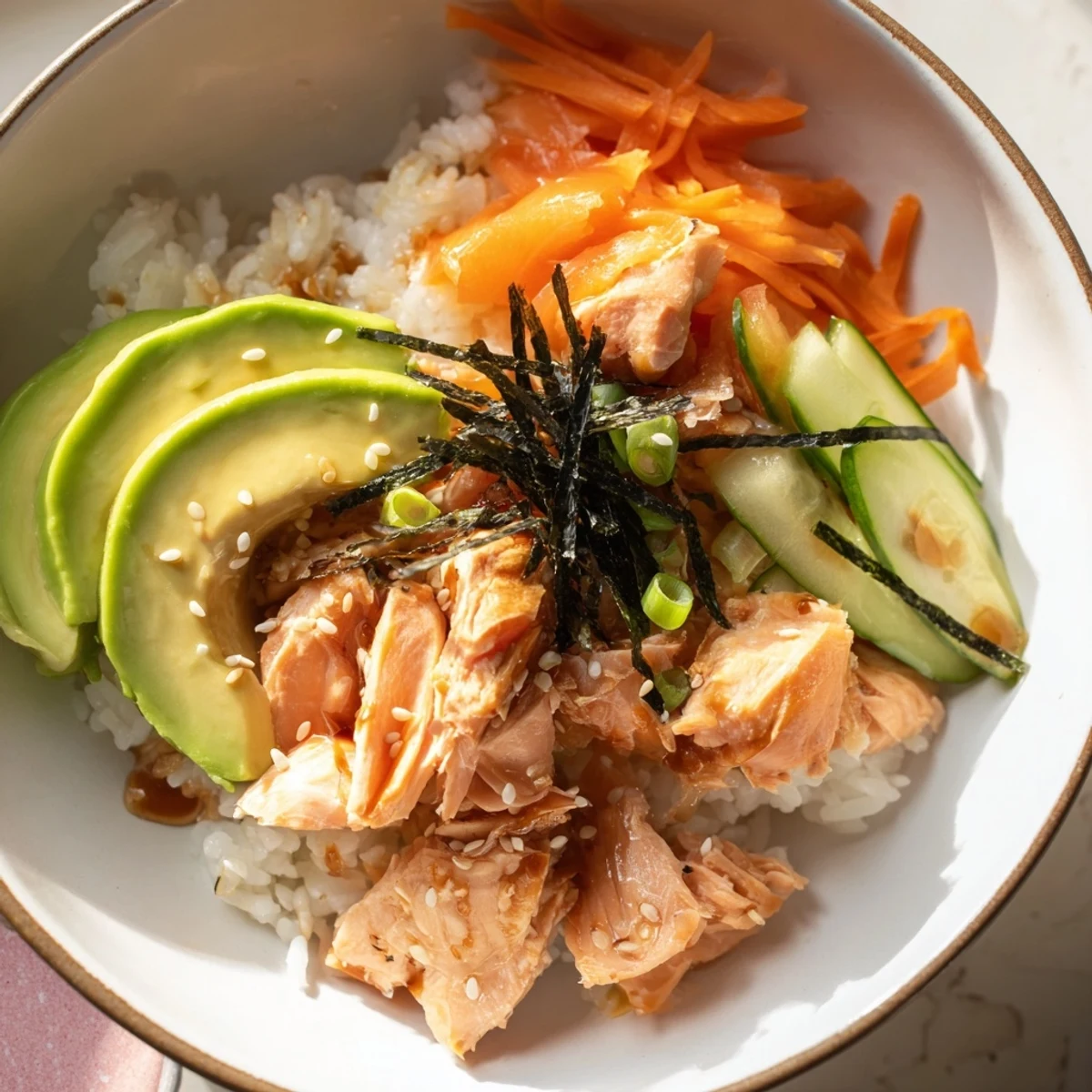 A close-up of a delightful Japanese-Style Salmon & Chicken Rice Bowl, boasting perfectly cooked salmon and savory chicken.