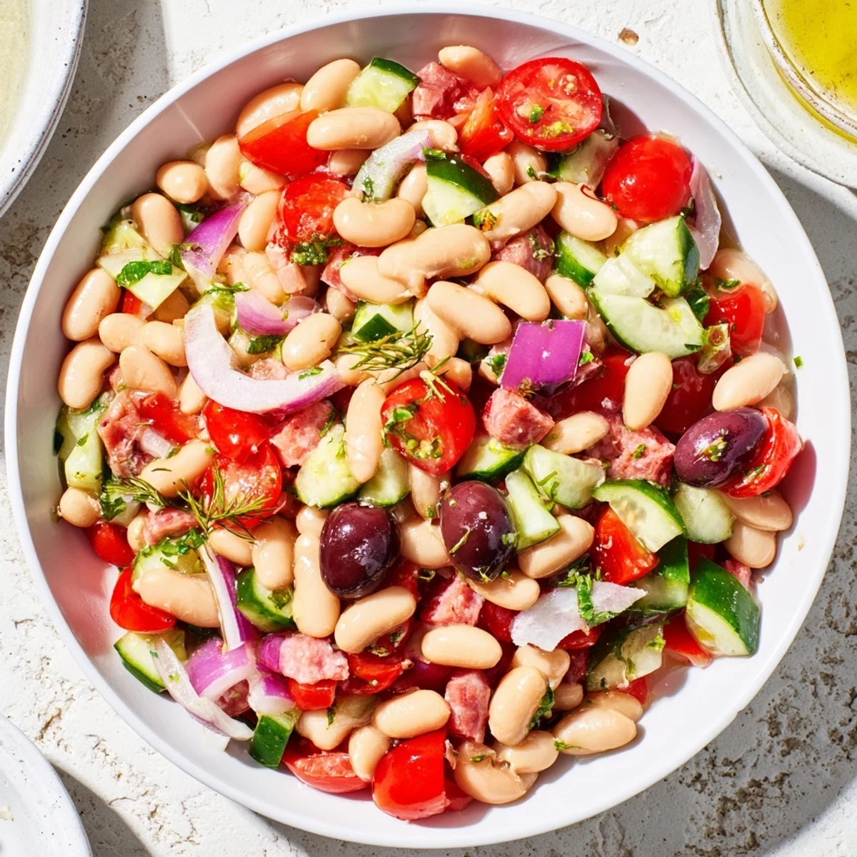 Mediterranean Bean Salad with salami featuring bright veggies, a perfect gluten-free lunch option.