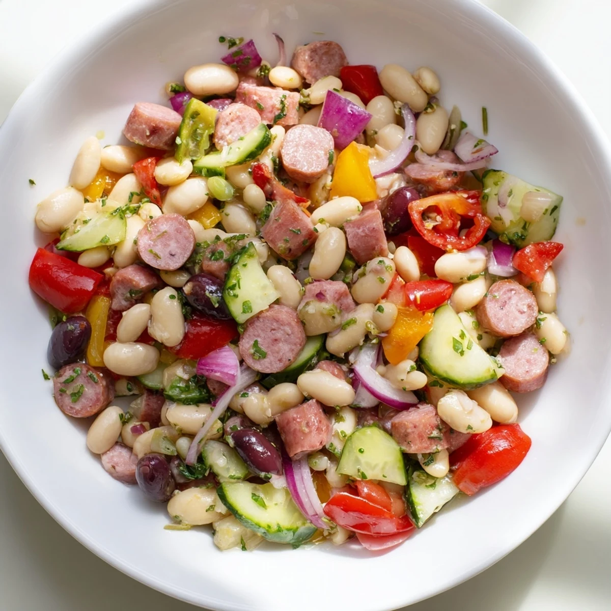This Mediterranean Dense Bean Salad with salami is a colorful, easy-to-make salad bowl ready to serve.