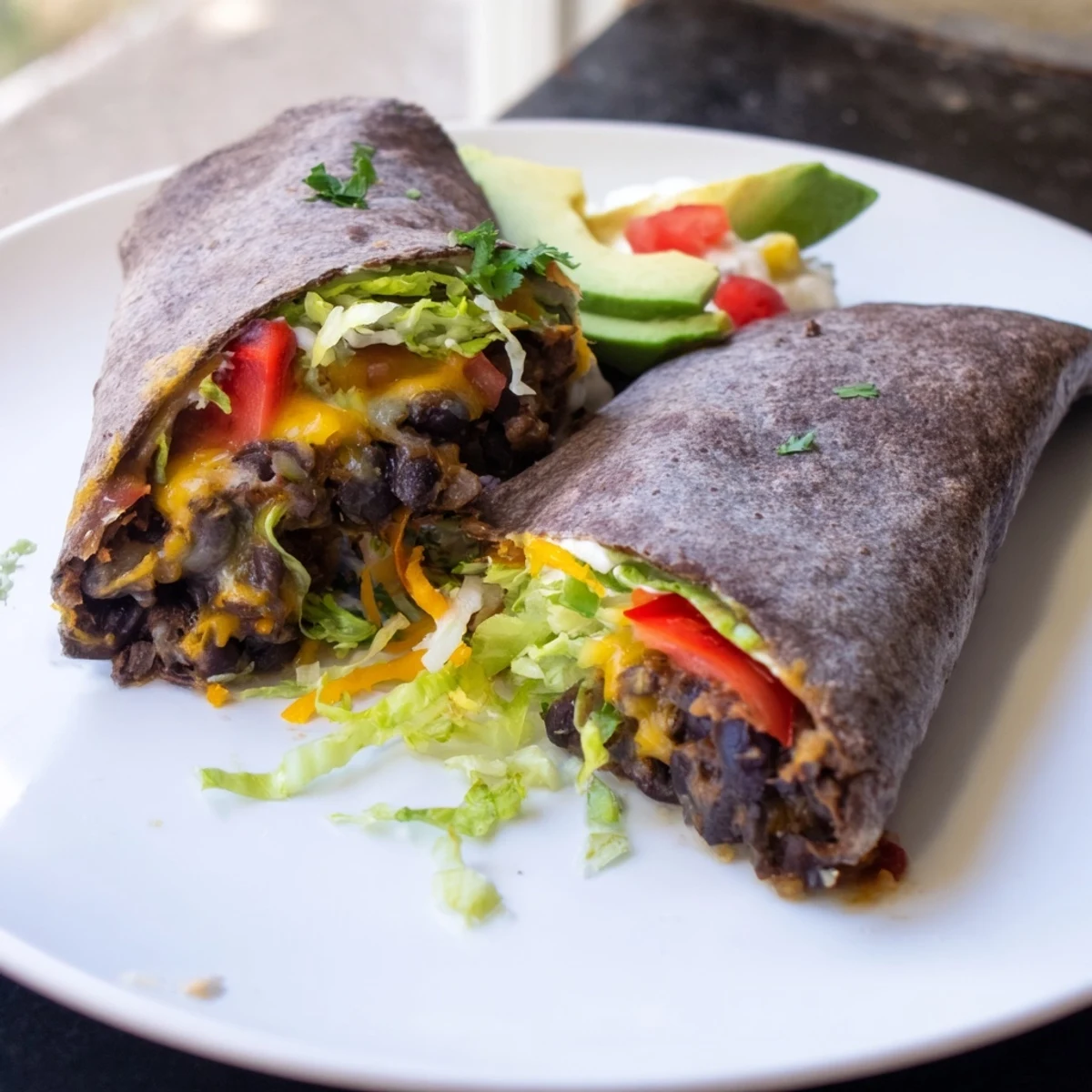 Steaming Smoky Black Bean Burrito, filled with savory beans, vegetables, and creamy toppings, ready to eat.