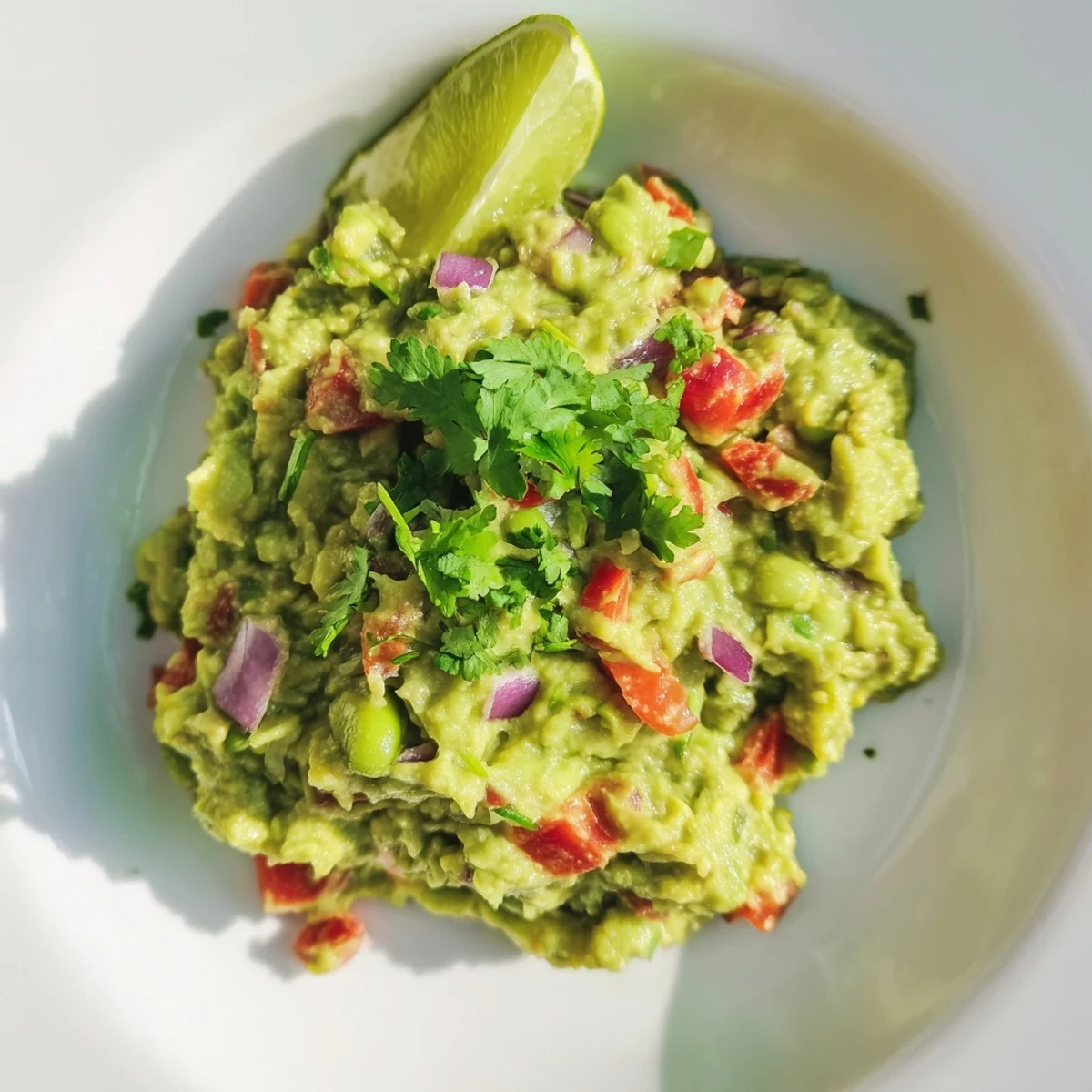 Imagine rich green Edamame Guacamole, speckled with red tomato, ready for tortilla chips.