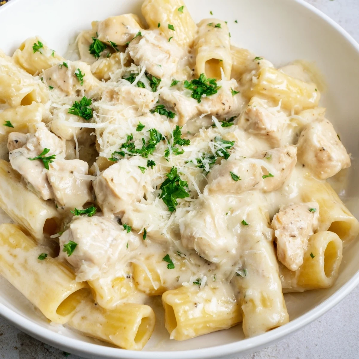 Golden, bubbling Chicken Alfredo Bake with cheesy topping, perfect family dinner visual.