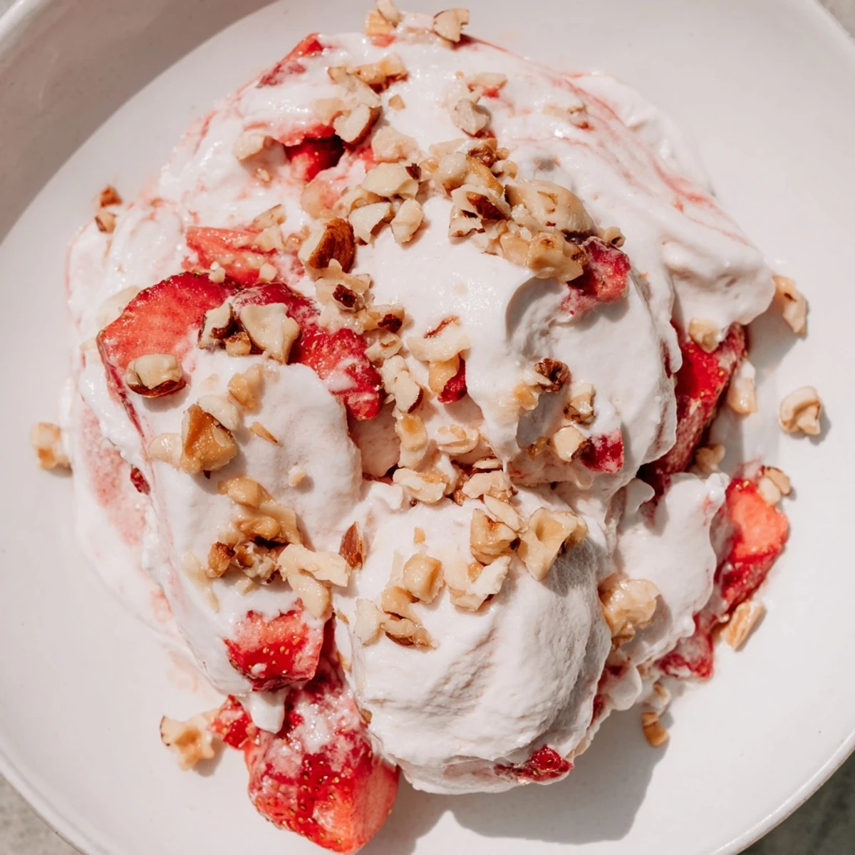Creamy cottage cheese ice cream with fresh strawberries, ready to scoop and enjoy.