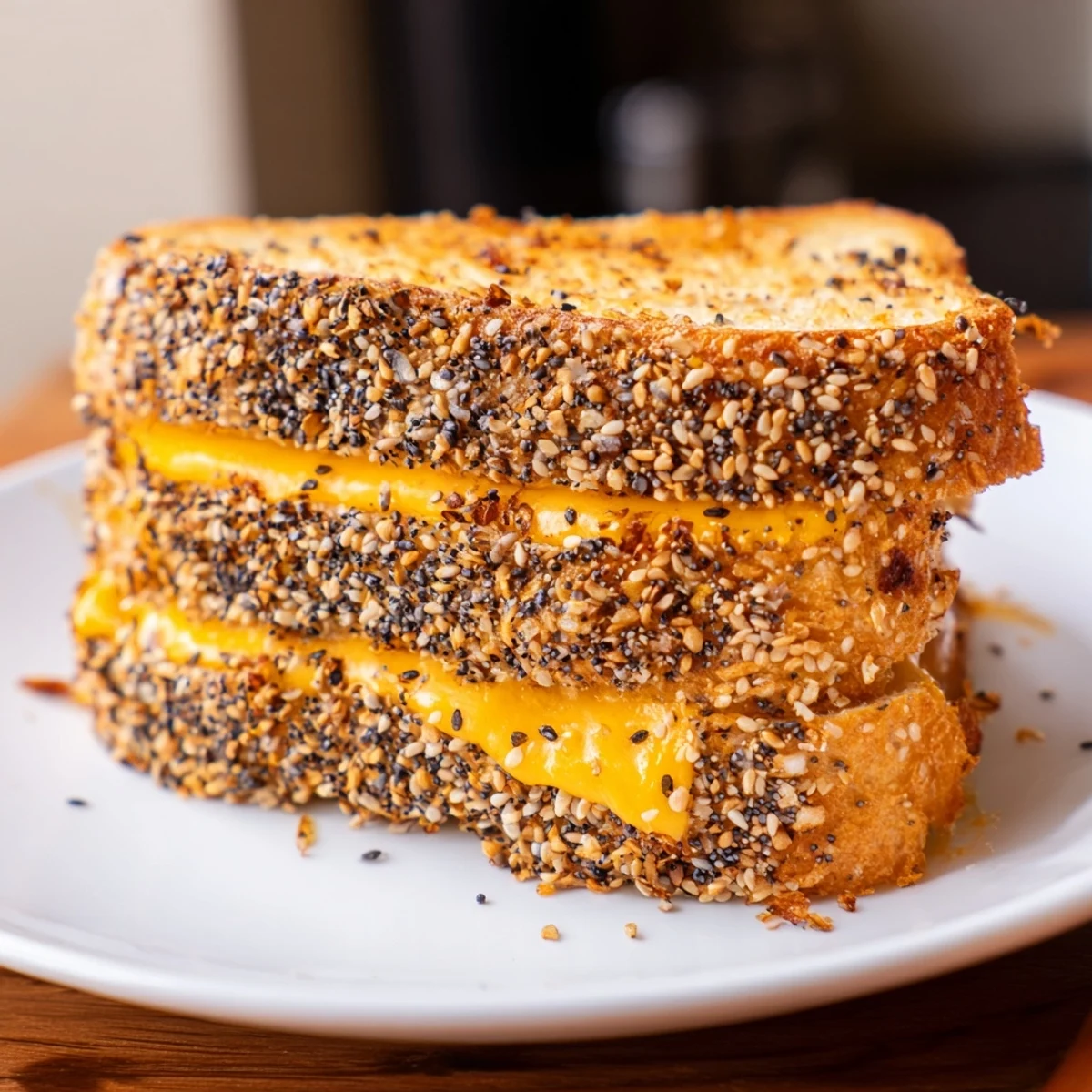 A close up shows the delicious Everything Bagel Grilled Cheese ready to be devoured with tomato soup.
