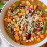 Warm, flavorful Tomato Basil Minestrone served with crusty bread, perfect for a cozy dinner.