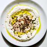 Tangy homemade labneh, a creamy appetizer or spread, beautifully garnished with herbs and spices.