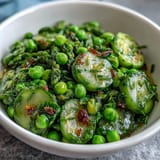 Shaved Asparagus and Pea Salad with Lemon Dressing, fresh spring greens tossed in zesty citrus vinaigrette, vibrant seasonal vegetables, and nutty Parmesan topping.