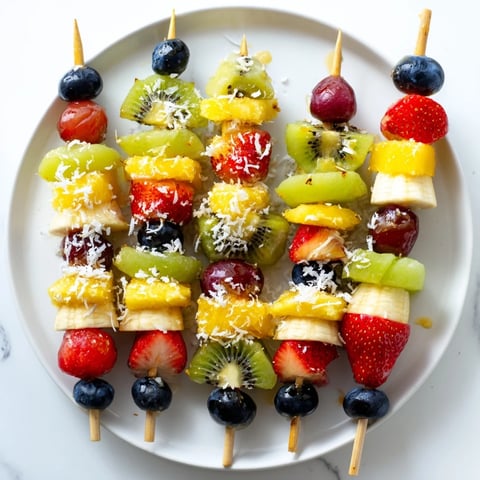 Fresh, colorful Easy Festive Fruit Kabobs, ready for your BBQ—a healthy, sweet snack or dessert.
