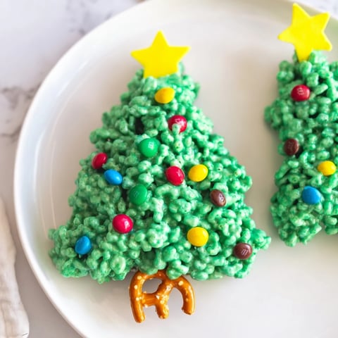 Golden-green Christmas Tree Rice Crispy Treats, a sweet treat with colorful candies atop marshmallow trees.