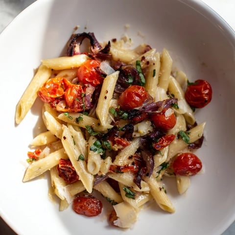 Image of Baked Tomato & Olive Oil Pasta, glistening with roasted tomatoes and fresh basil.