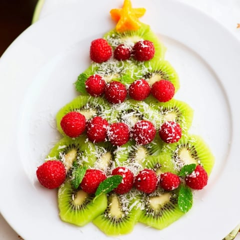 Fresh kiwi and ruby-red raspberries make this Kiwi and Raspberry Christmas Tree Fruit Plate festive.