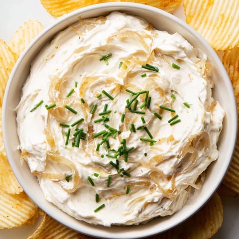 Crispy, golden potato chips ready to be dipped into the creamy, flavorful onion dip.