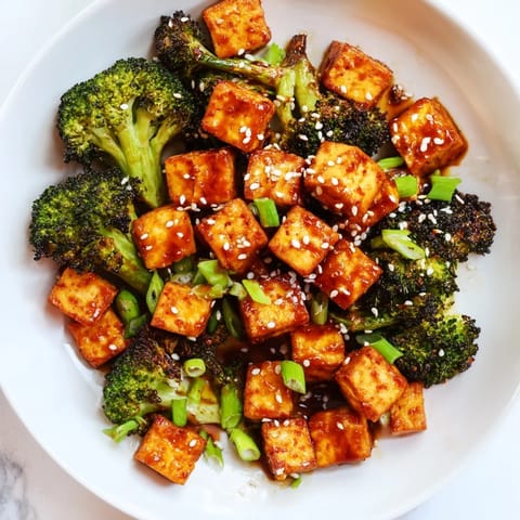 Close-up of Crispy Baked Tofu with Sesame-Chili Sauce, showing its perfect crispy texture and sesame seed garnish.