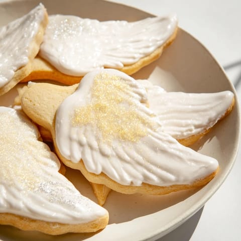 These beautiful Angel Wings sugar cookies are lightly dusted, appearing delicate and ready to eat.