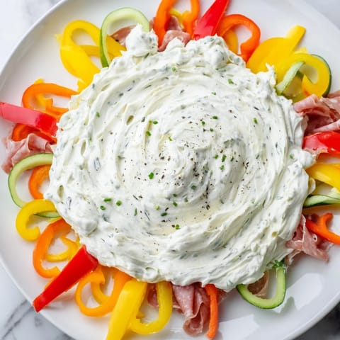 Appetizing The Medusa Curls presentation with rolled meats and vibrant veggies ready as party appetizer.