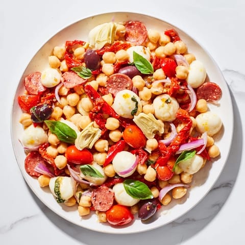 A close-up shot of the fresh and flavorful Antipasto Chickpea Salad, ready to eat.