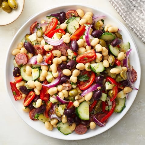 Fresh, flavorful Mediterranean Bean Salad with salami, a vibrant mix of beans, olives, and salami.