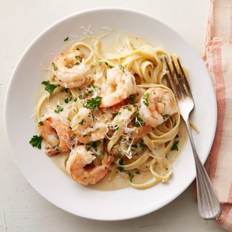 A close-up of Creamy Garlic Shrimp Pasta with glossy sauce and fresh parsley garnish, perfect for a quick weeknight dinner.
