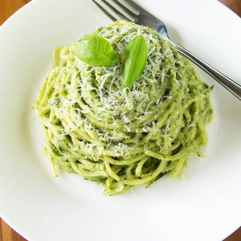 Fresh spiralized zucchini tossed in fragrant pesto, finished with pine nuts and a squeeze of lemon for brightness.