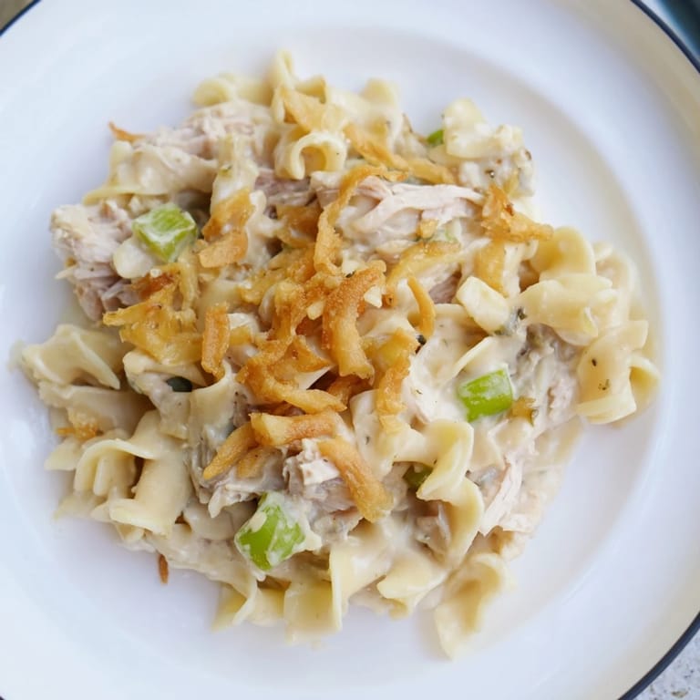 A close-up view of the baked Creamy Tuna Noodle Casserole, showcasing creamy sauce and crispy onions.