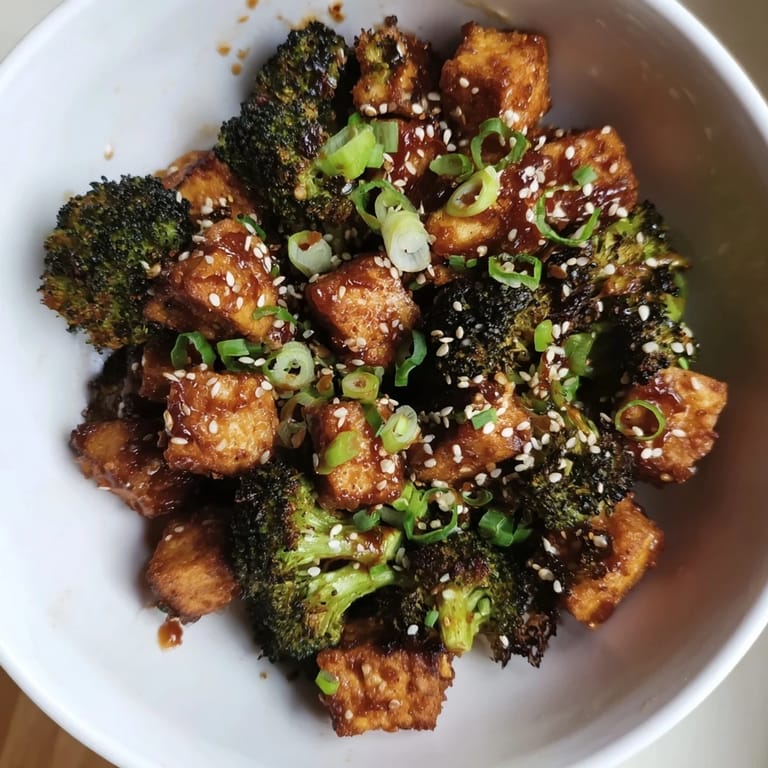 Sheet pan featuring Crispy Baked Tofu with Sesame-Chili Sauce & broccoli, ready to enjoy for a delicious vegan dinner.