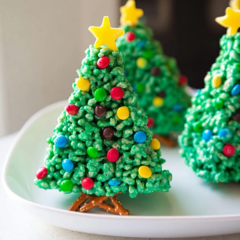 Homemade Christmas Tree Rice Crispy Treats are festively decorated with candies, a joy for any holiday dessert table.