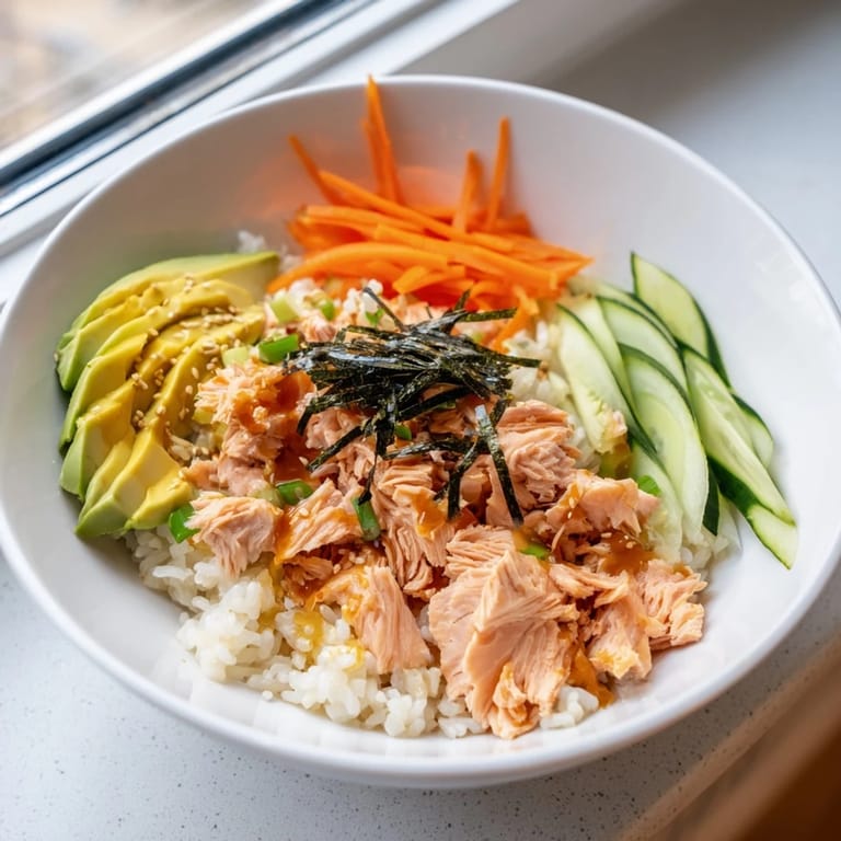 Steaming hot Japanese-Style Salmon & Chicken Rice Bowl: a visually stunning arrangement, ready to eat and enjoy.