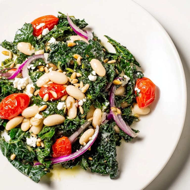 Vibrant bowl of White Bean and Kale Salad featuring tender kale, white beans, and tomatoes, drizzled with zesty lemon dressing.