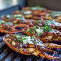 Golden sea scallops seared to perfection in a vibrant lemon butter sauce, served with fresh parsley and lemon wedges for a bright spring dinner.