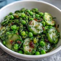 Shaved Asparagus and Pea Salad with Lemon Dressing, fresh spring greens tossed in zesty citrus vinaigrette, vibrant seasonal vegetables, and nutty Parmesan topping.